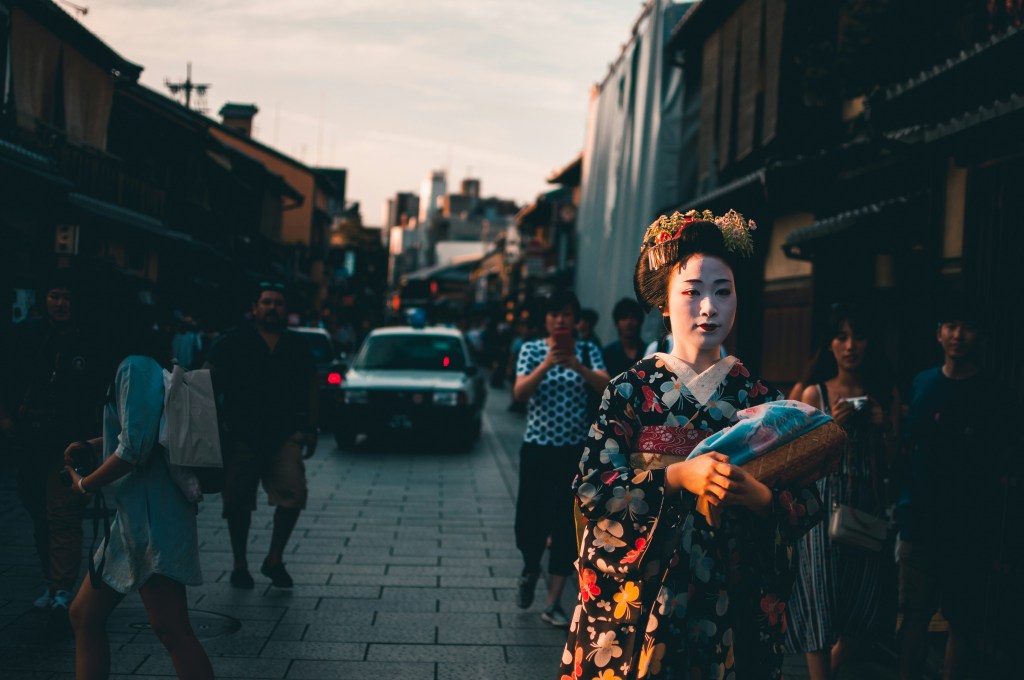 Geisha walking through Gion district street, a top cultural attraction in Kyoto Japan