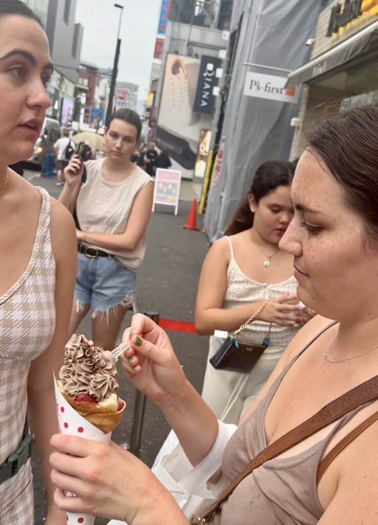 girls eating crepes in Harajuku Tokyo on Takeshita Street
