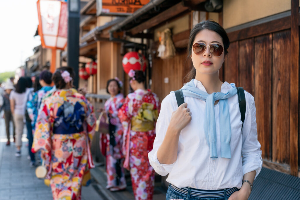 Woman in Kyoto wearing a lightweight sweater over a white shirt, casual spring outfit for Japan travel