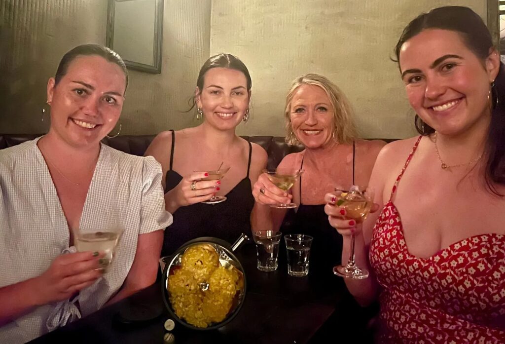 Mother and adult daughters enjoying cocktails together at a bar in Tokyo Japan on a family trip