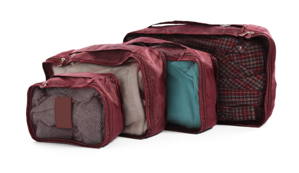 packing cubes organizing clothes inside suitcase for travel efficiency