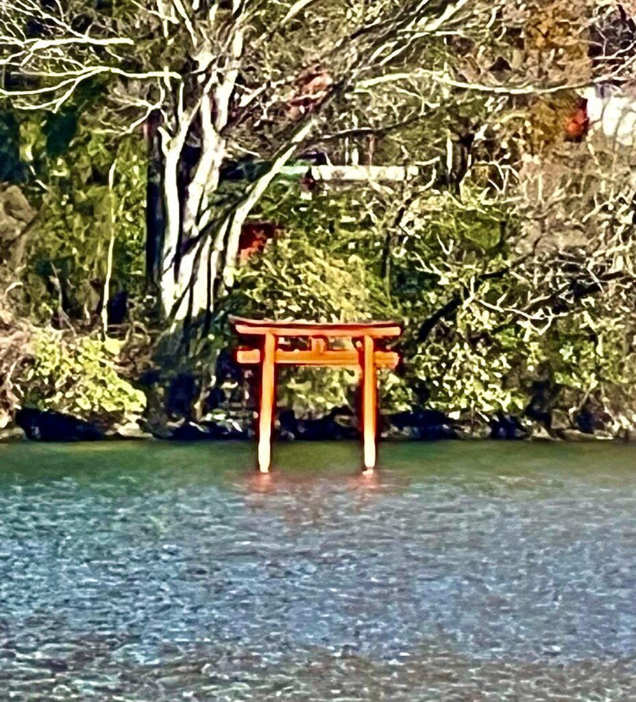 The iconic red torii gate of Hakone Shrine standing in Lake Ashi in Hakone, Japan.